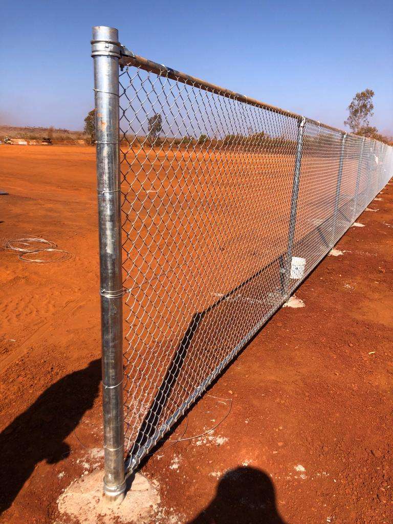 Galvanised chain link fence on steel posts with concreted footings