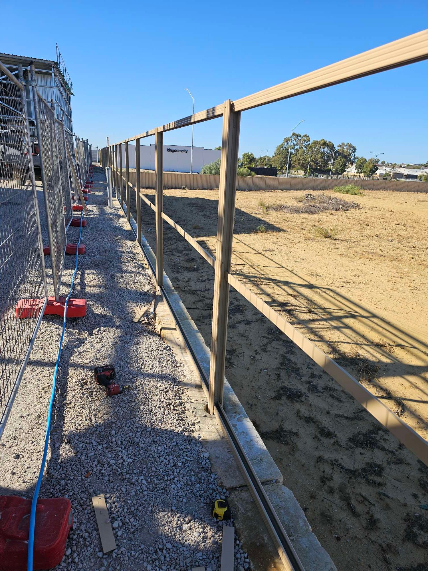 Commercial Colorbond fence frame going up on a Perth development site