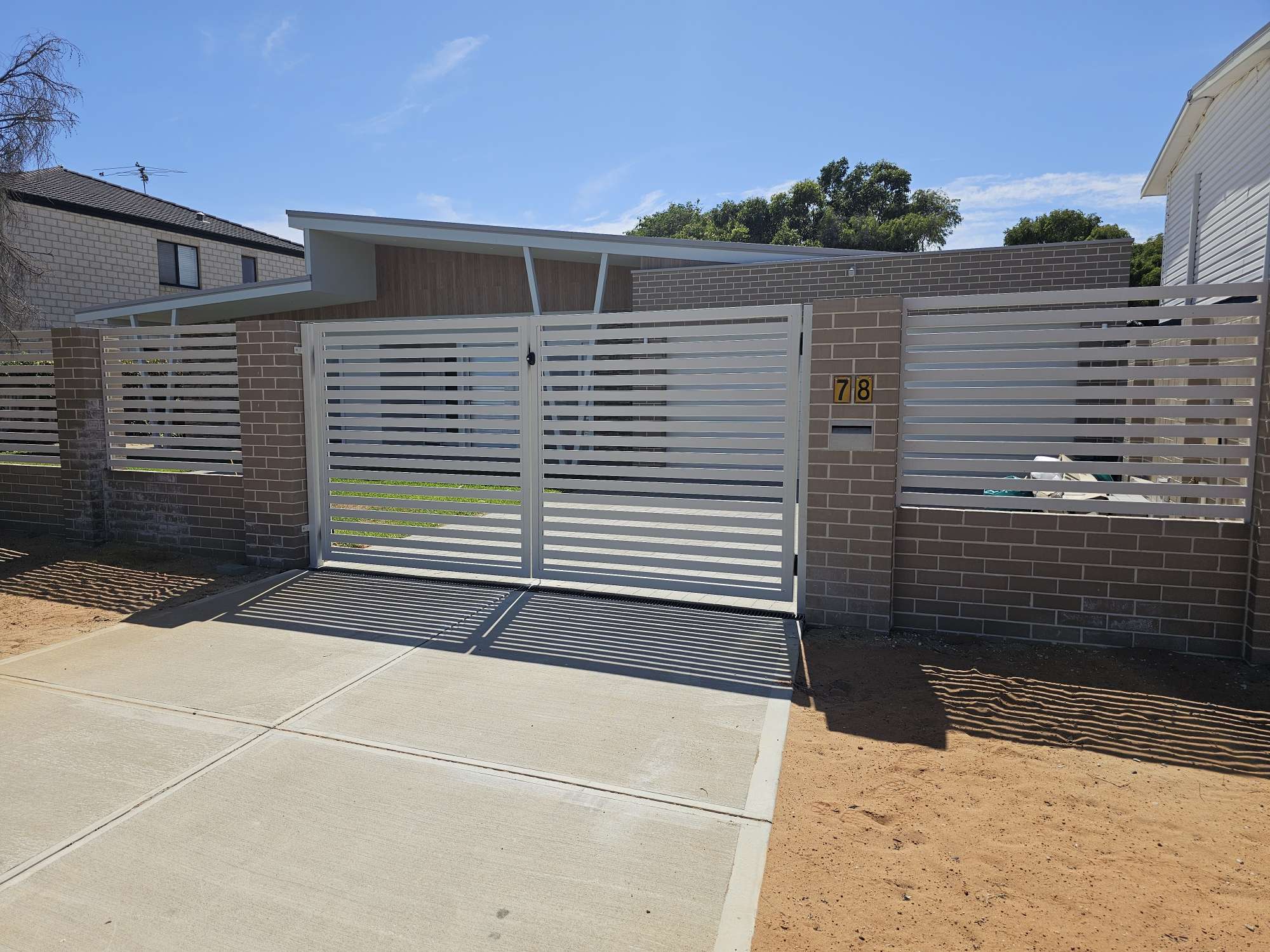 Custom white aluminium slat driveway gates