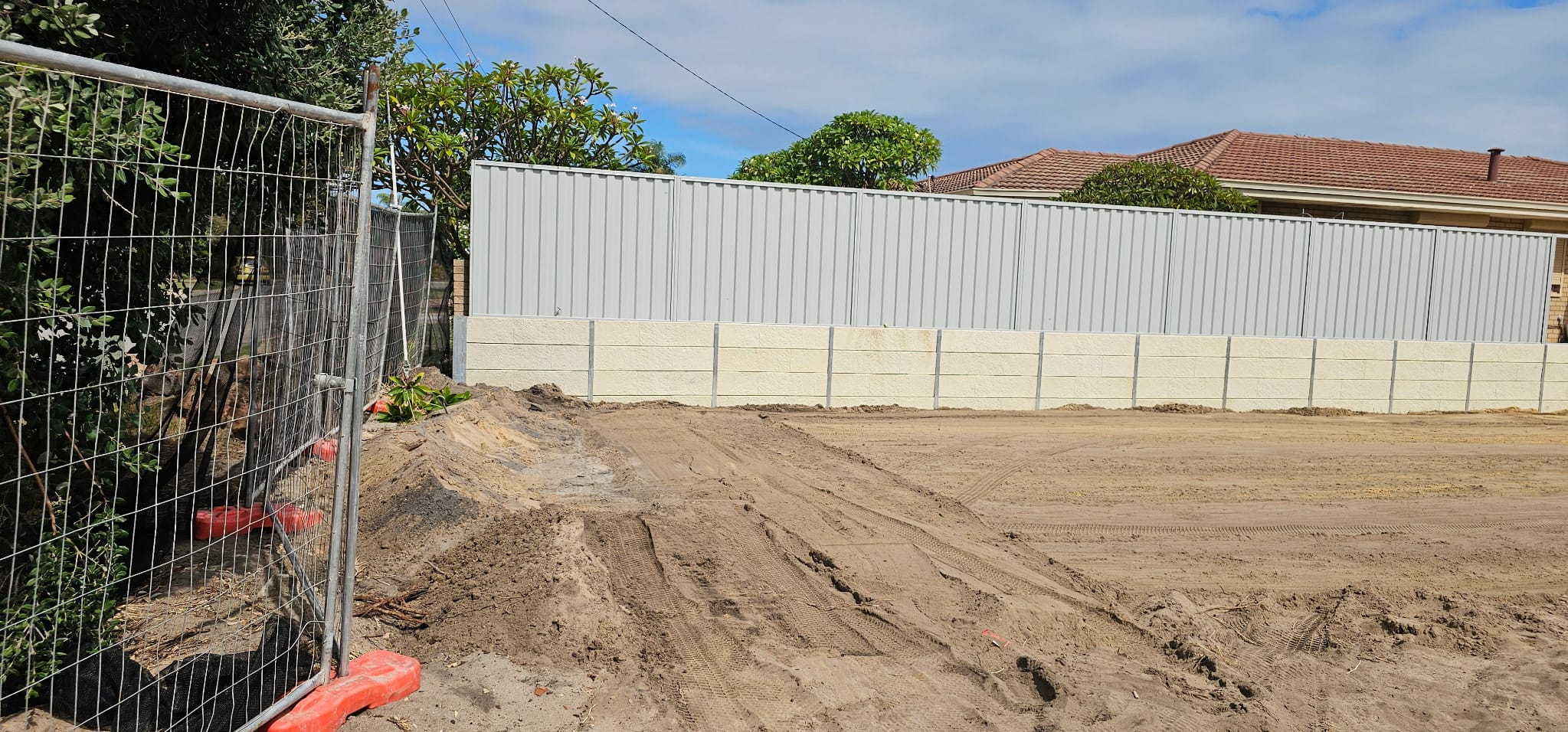 Surfmist Colorbond fence on a concrete sleeper retaining wall